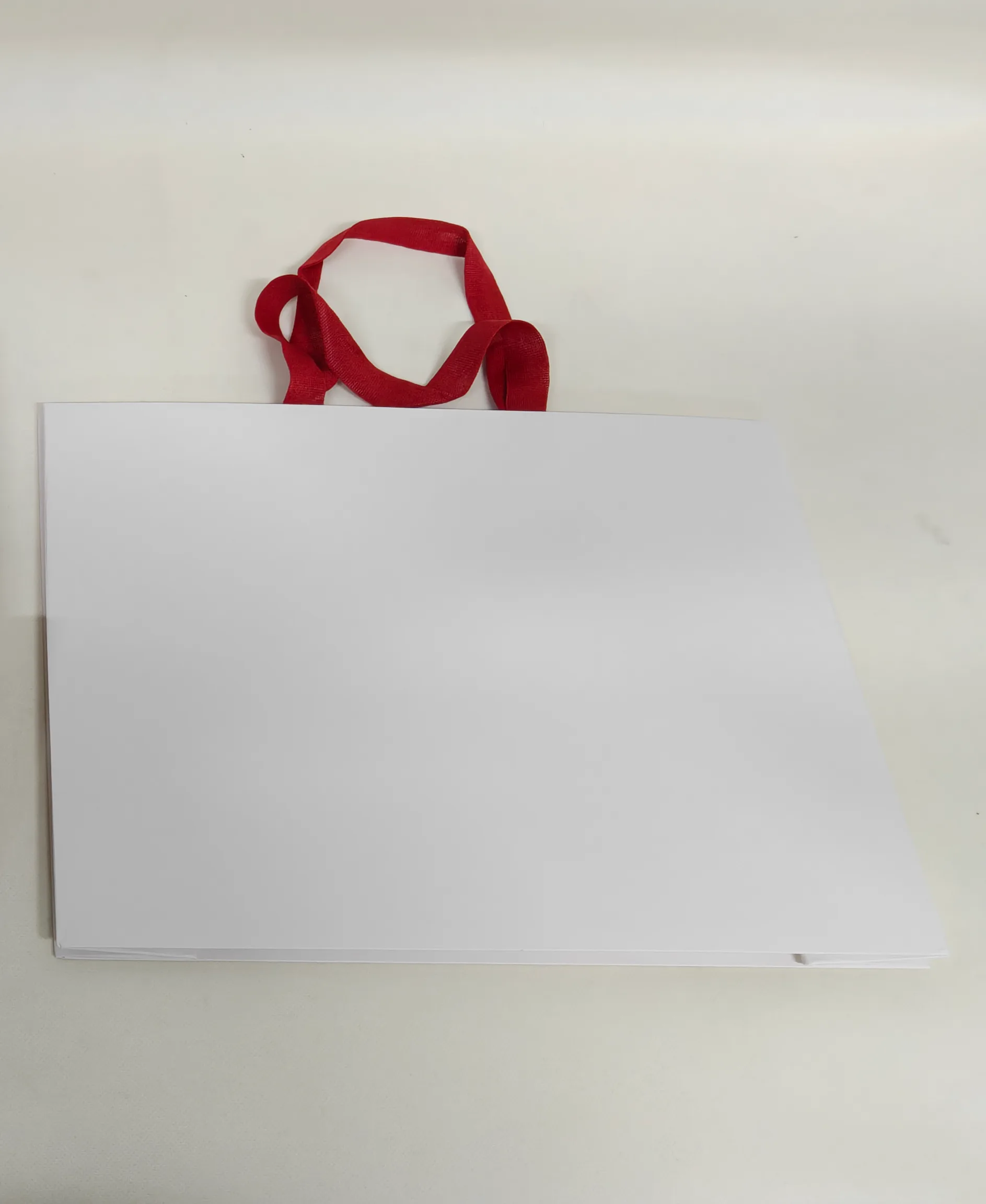 Bag produced on a seamless paper bag machine with a continuous side wall and no visible seam