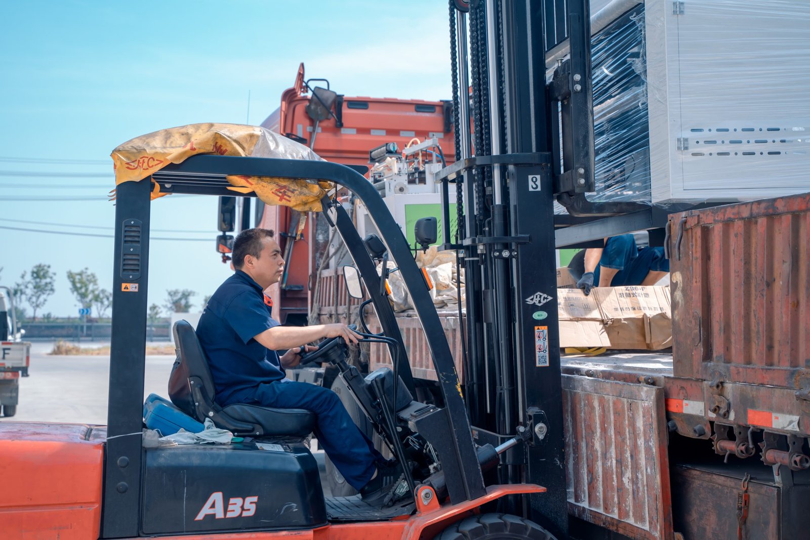 Forklift handling machinery during the loading process