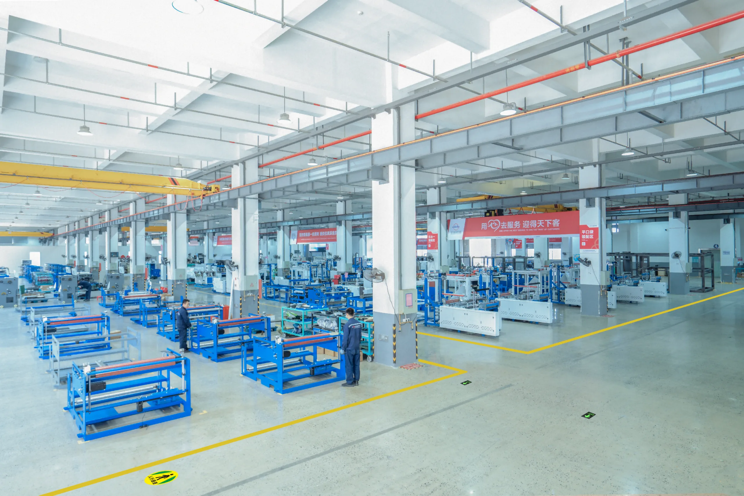 ZHENGWEI technicians assembling a seamless paper bag making machine