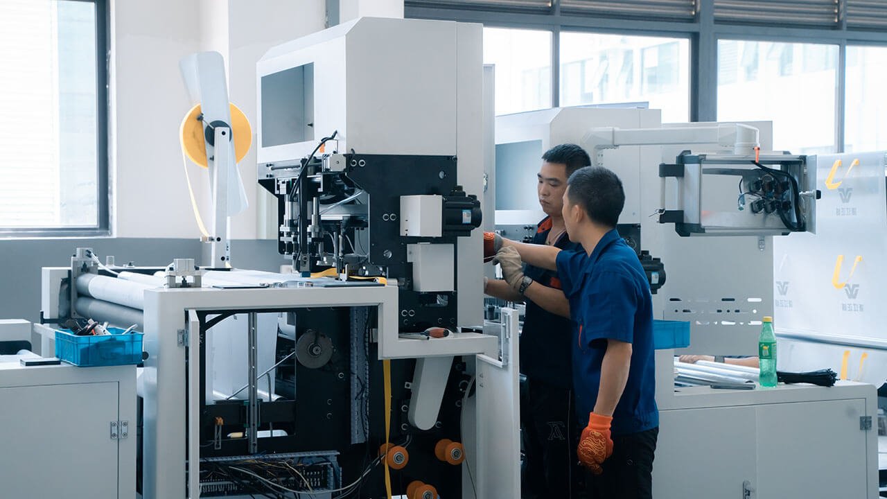 Worker handling machinery components in the production hall