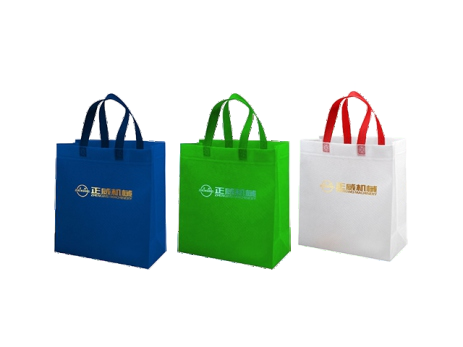 ZW-A8 sample output — three non-woven shopping bags in blue, green, and white with branded prints