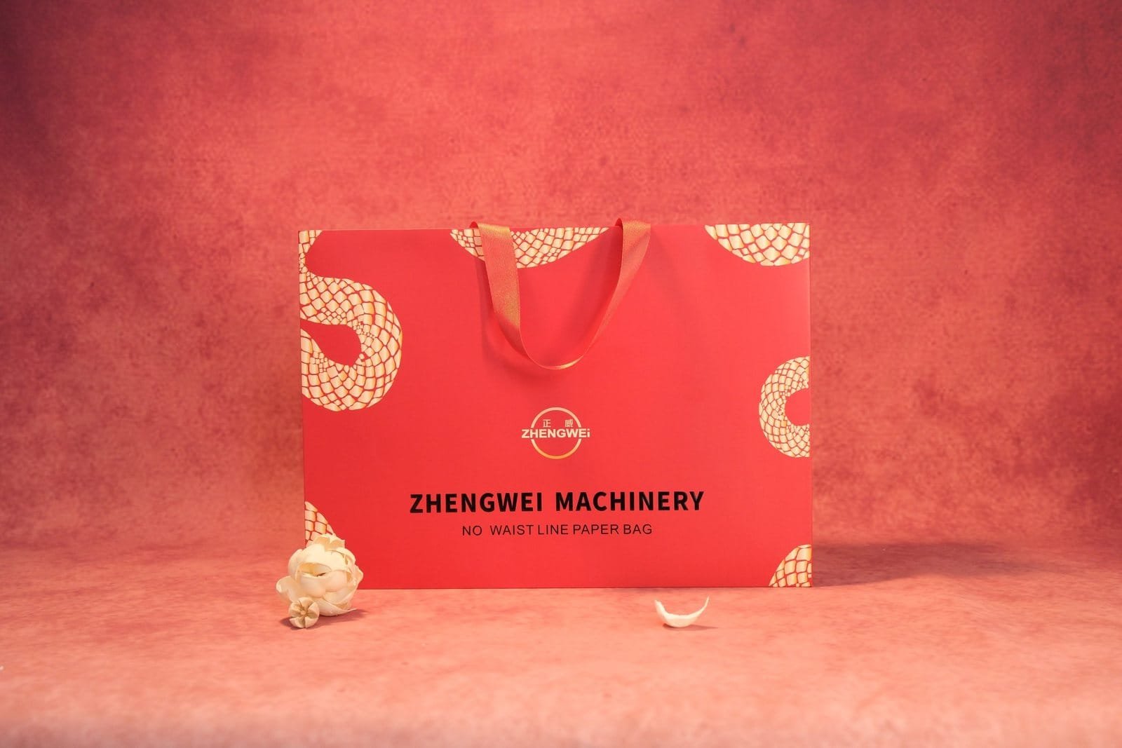 Red paper bag sample with gold foil pattern and flat handles