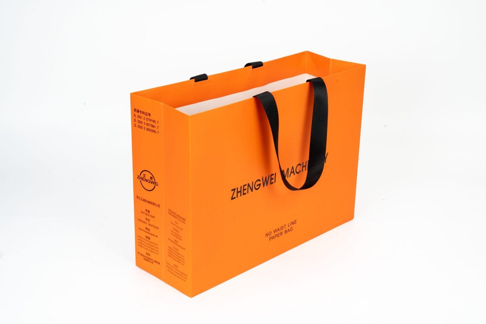 Orange paper bag sample with dark ribbon handles and printed panel