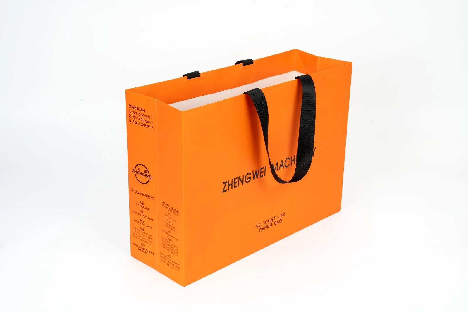 Orange paper bag sample with dark ribbon handles and printed panel